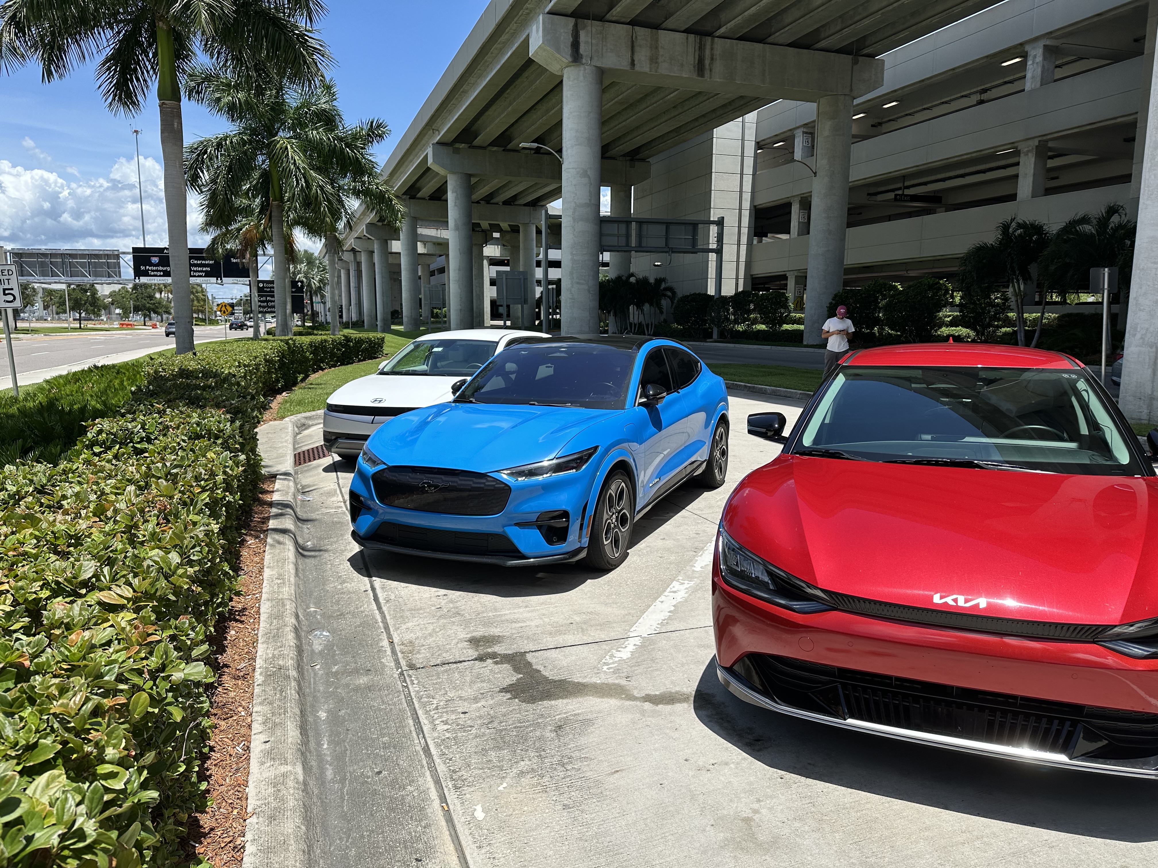 Ford Mustang Mach-E and Kia EV6 electric vehicles at Tampa International Airport